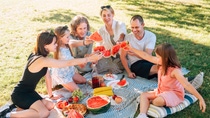 Family having a picnic with fresh fruit