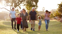 A happy family is walking in a park.
