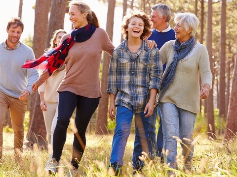 Happy family on a walk in the woods